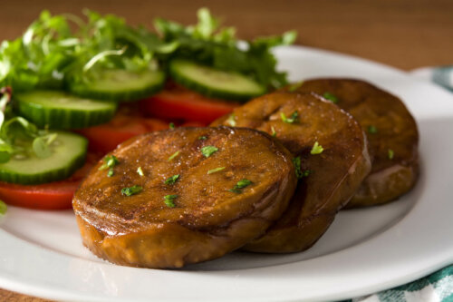 A dish of seitan steaks and vegetables.