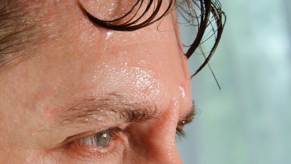 A man excessively sweating which is one of the symptoms of a cardiac arrest