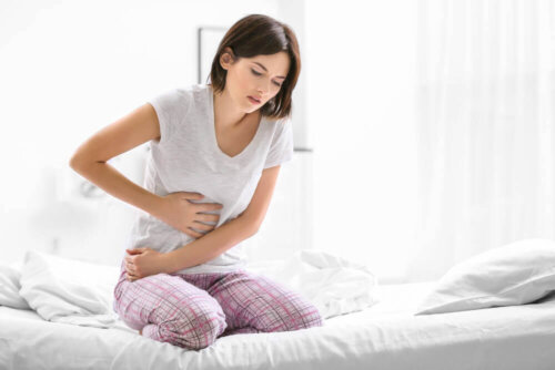 A woman in pain due to Helicobacter pylori.