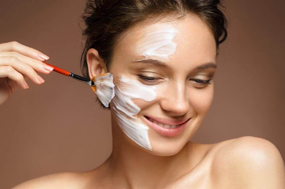 Woman pasting milk of magnesia on her face