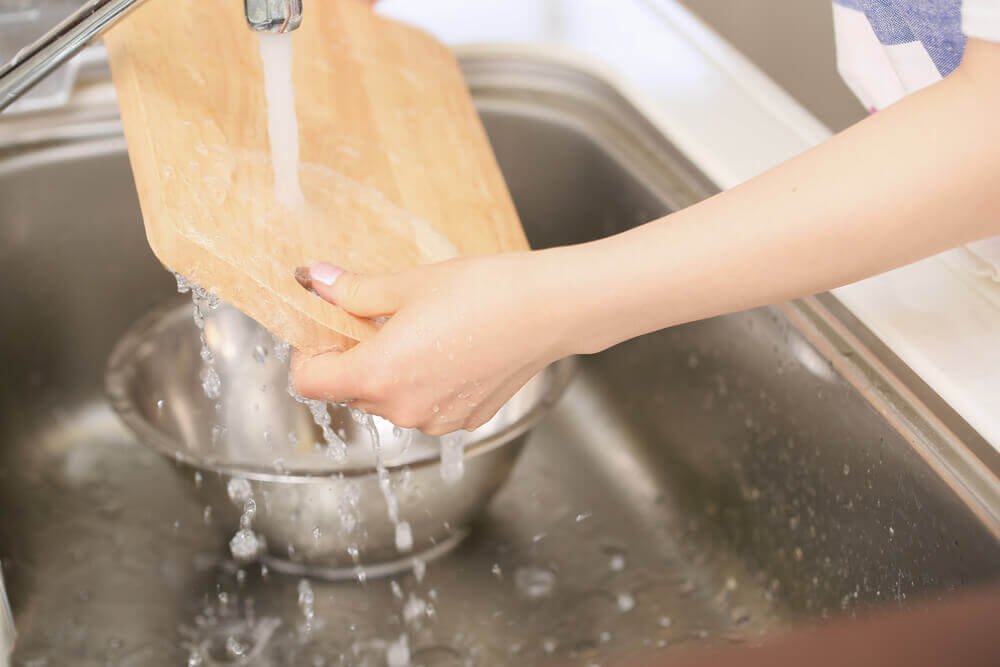 Woman washing cutting boards