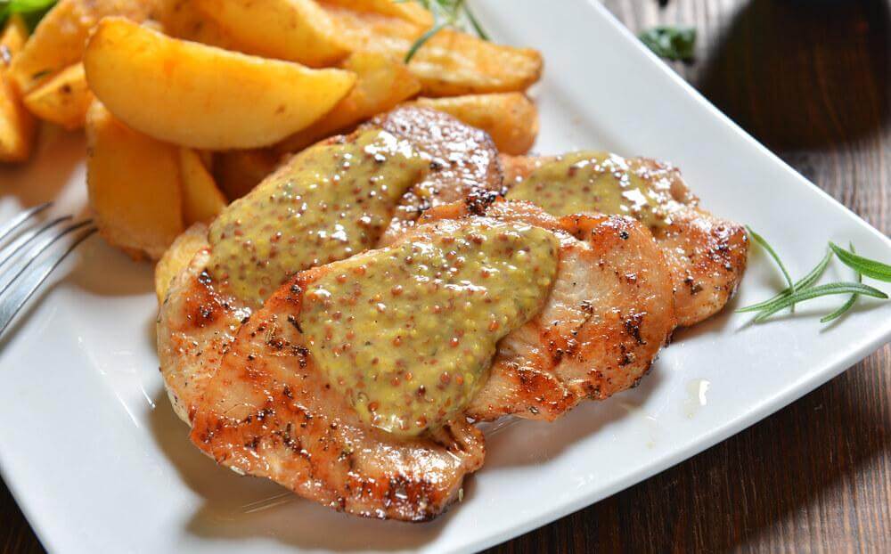 A chicken breast with fruit sauce.