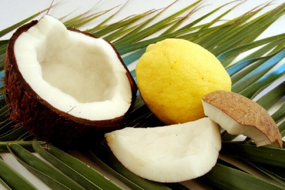 Coconut and lemons lying on leaves