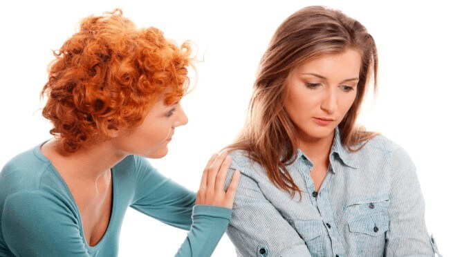 a woman comforting another sad woman