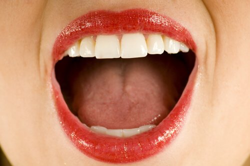 An open mouth with lipstick.
