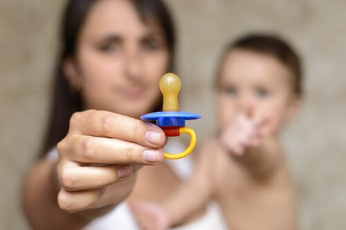 A woman showing off a pacifier.