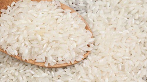 A wooden spoon in some rice