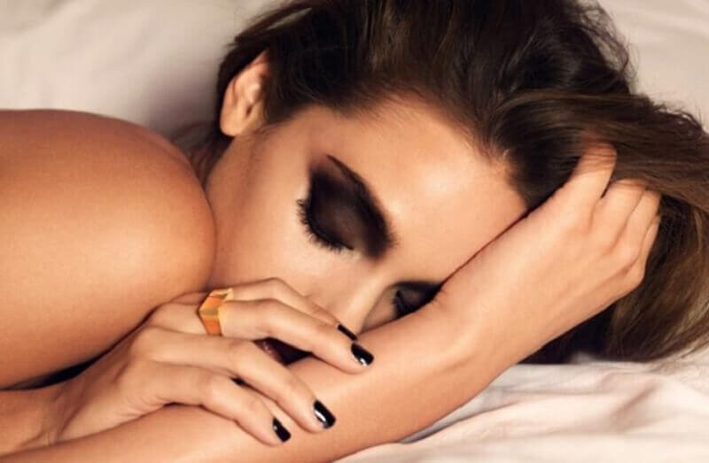 A woman sleeping with makeup on.