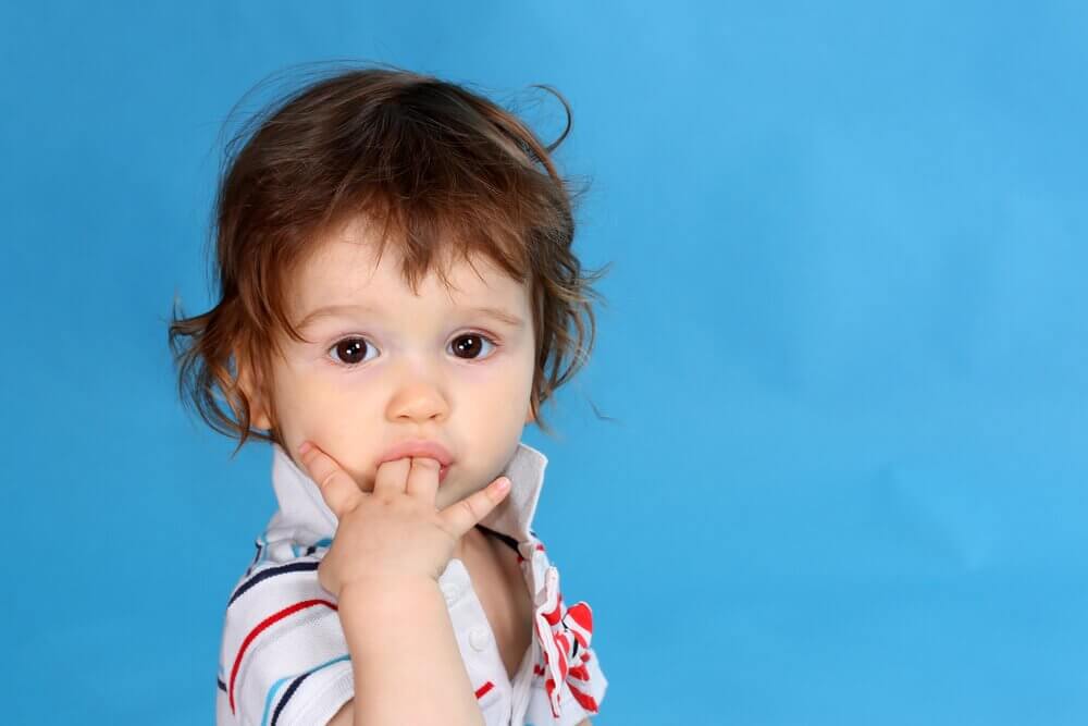 A child with the habit of sucking their thumb.