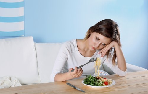 Woman bored with her food