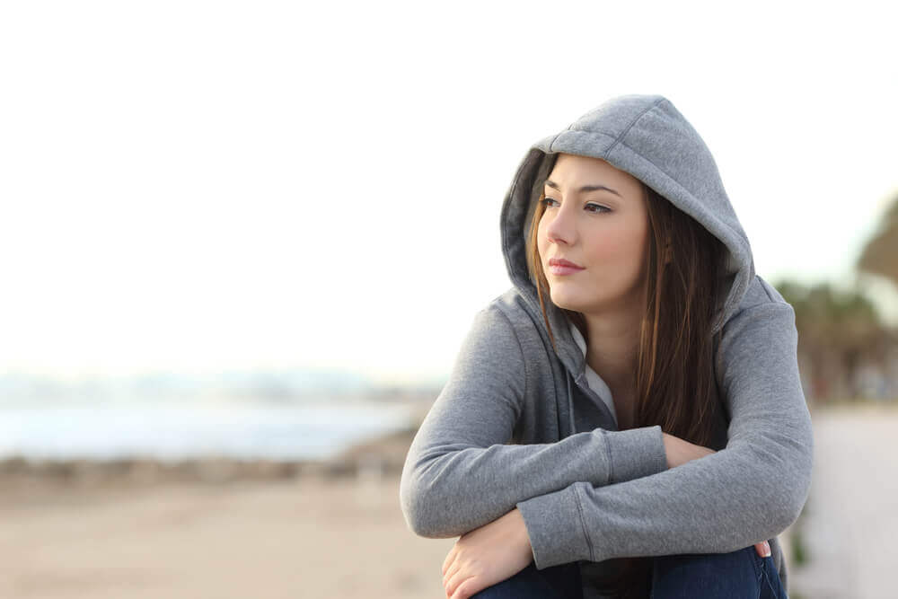 A girl sulking because of mood swings during adolescence.
