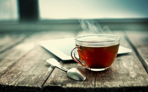 A cup of tea on a wooden bench