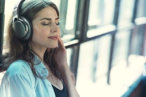 A woman listening to music which is important to get enough rest.
