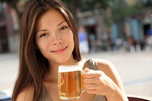 A woman enjoying a beer