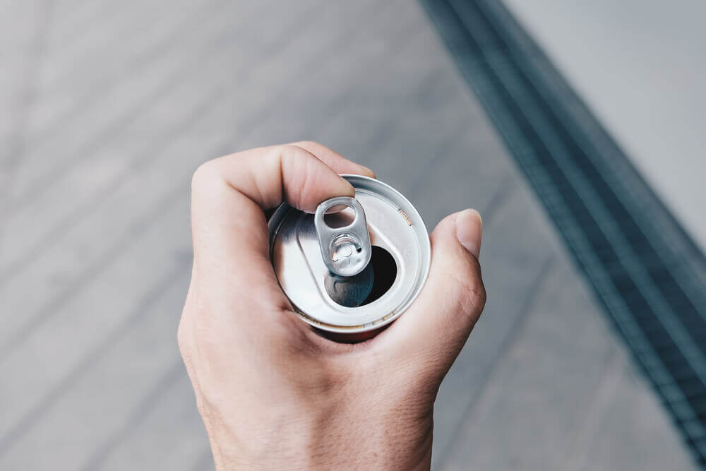 Someone holding an open drinks can