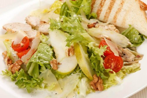 A Caesar salad with apple and mustard.
