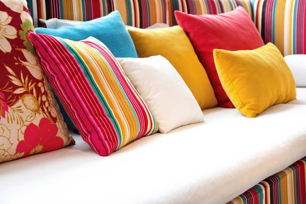 A sofa covered in decorative cushions
