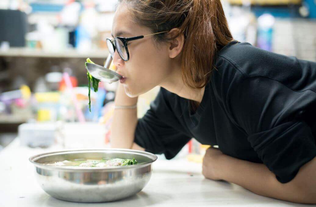 Woman drinking cabbage soup