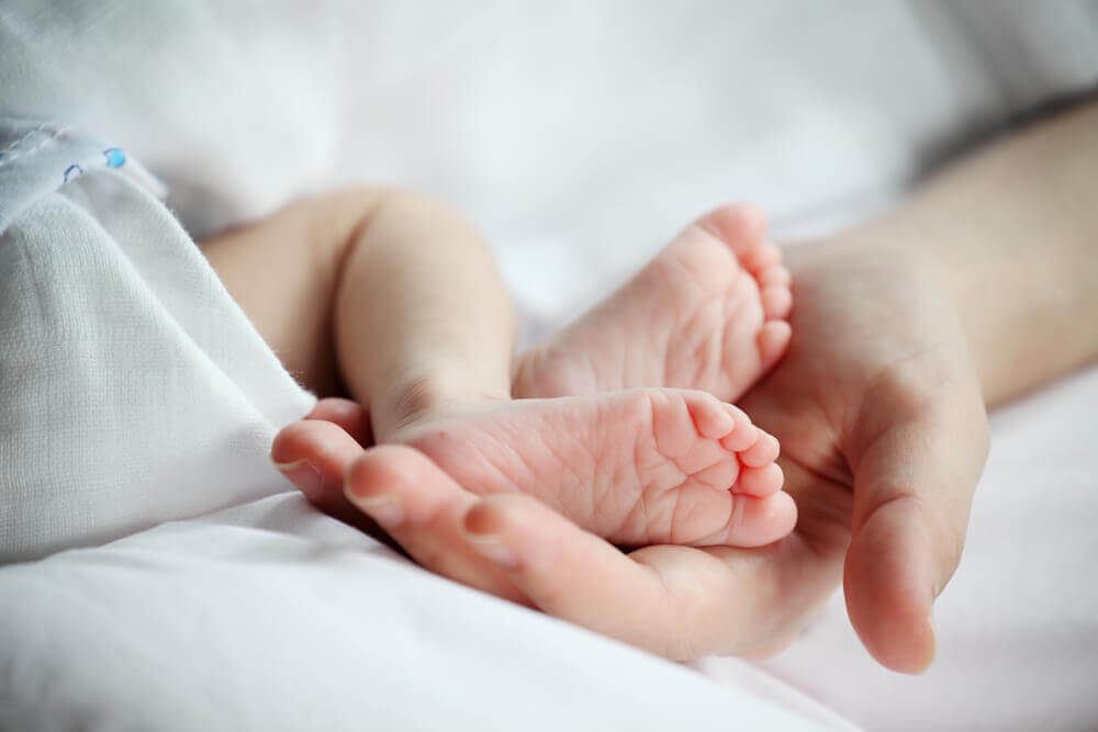 Woman holding her rainbow baby