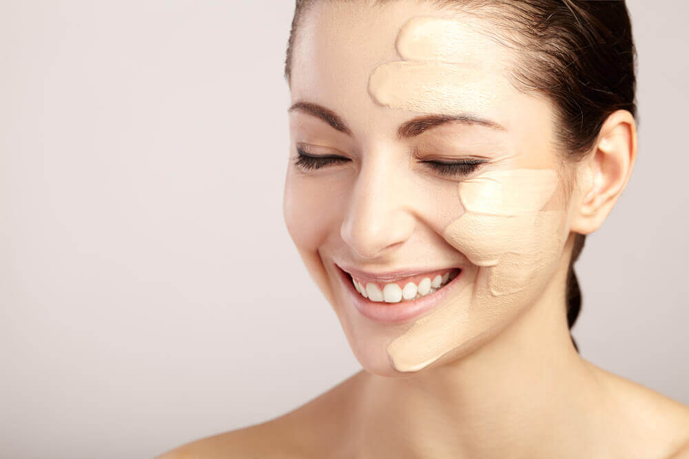 A woman applying makeup who has oily skin