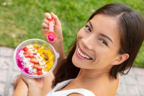 A girl eating a fruit salad.