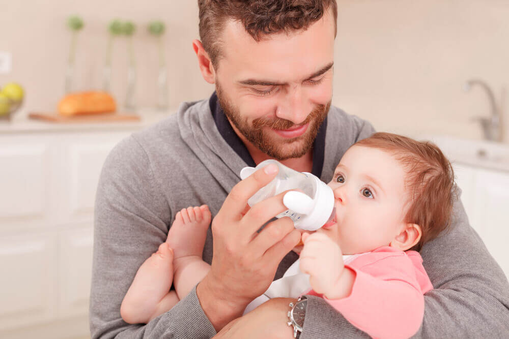 Man feeding a baby using the Kassing Method
