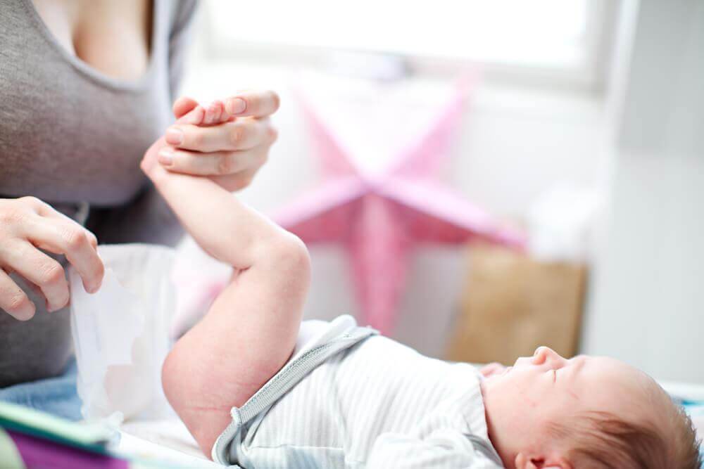 Mom changing her baby's diaper.
