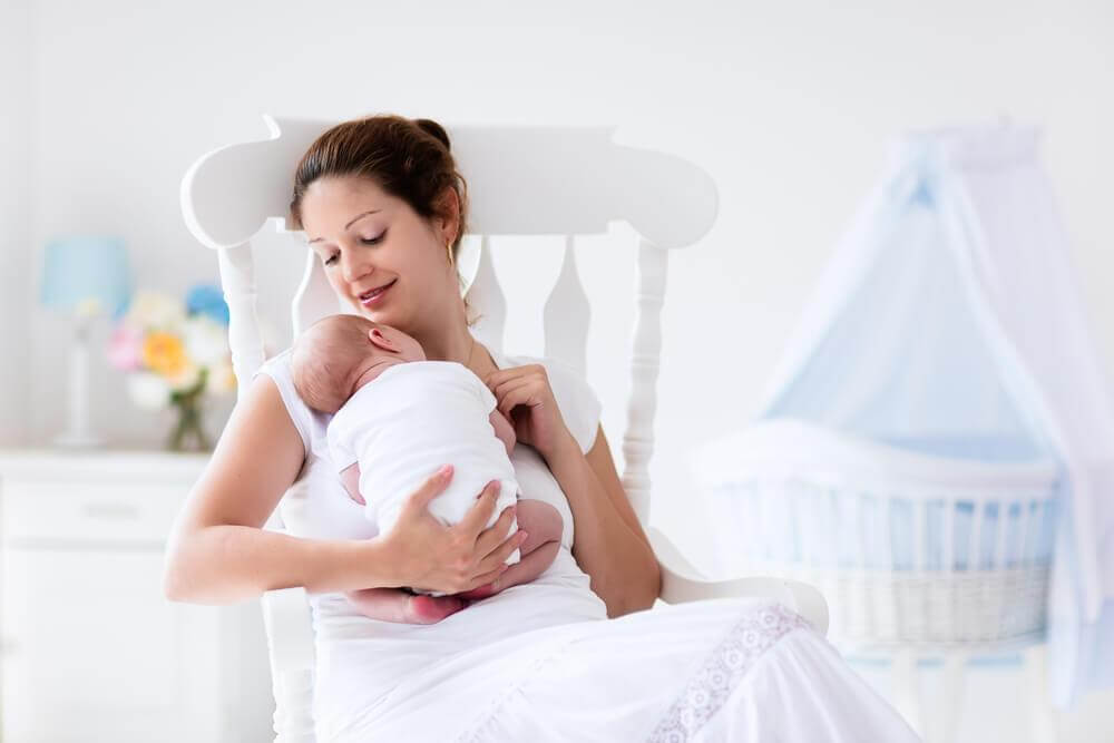 mom sitting with her newborn baby