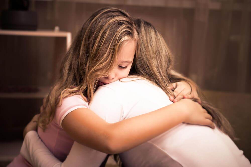 mother and daughter hugging each other