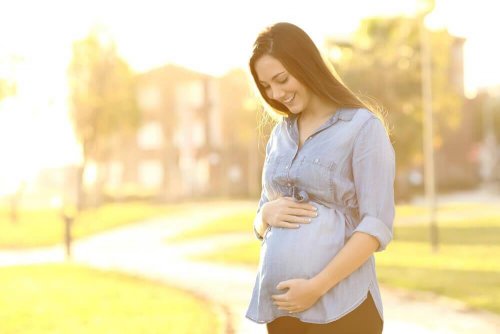 A pregnant woman smiling.