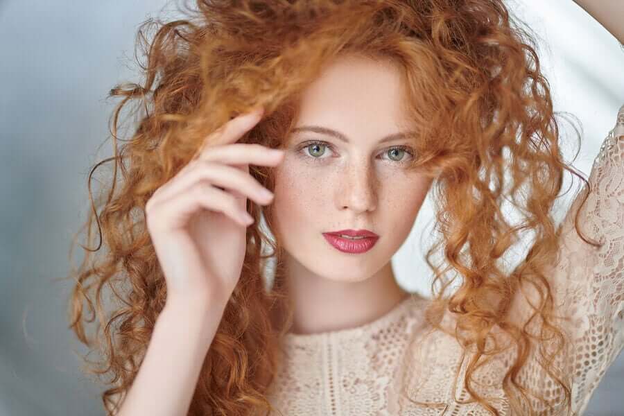 A woman with red, curly hair.