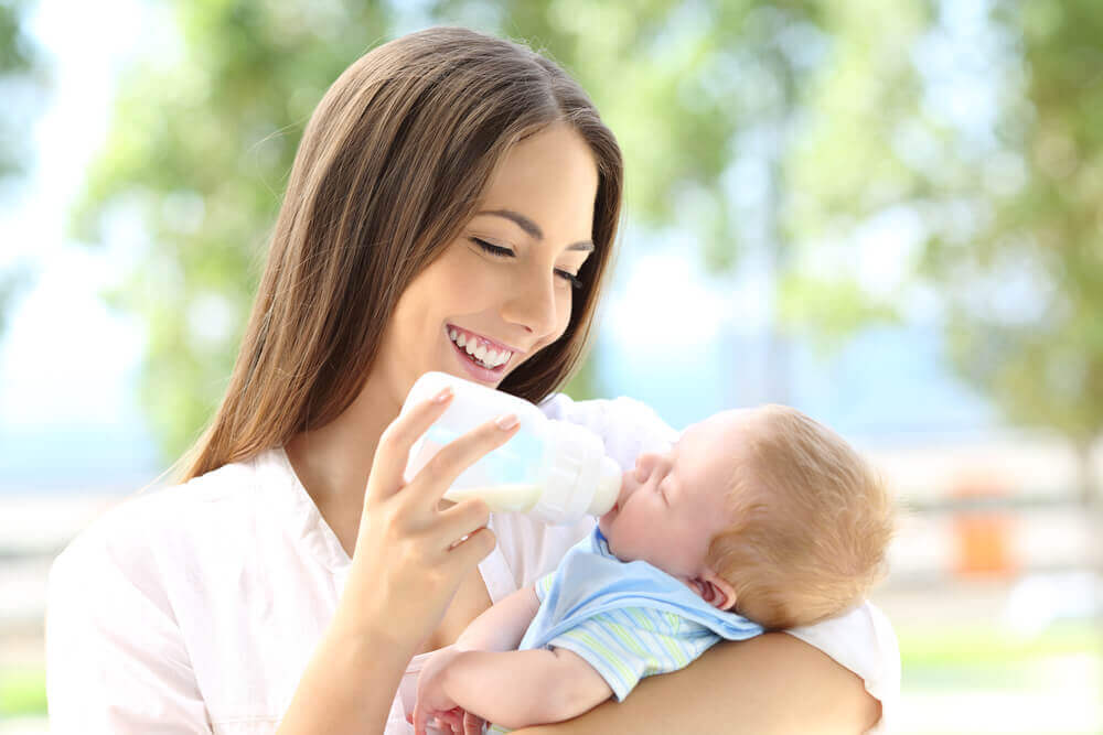 Woman bottle feeding her baby