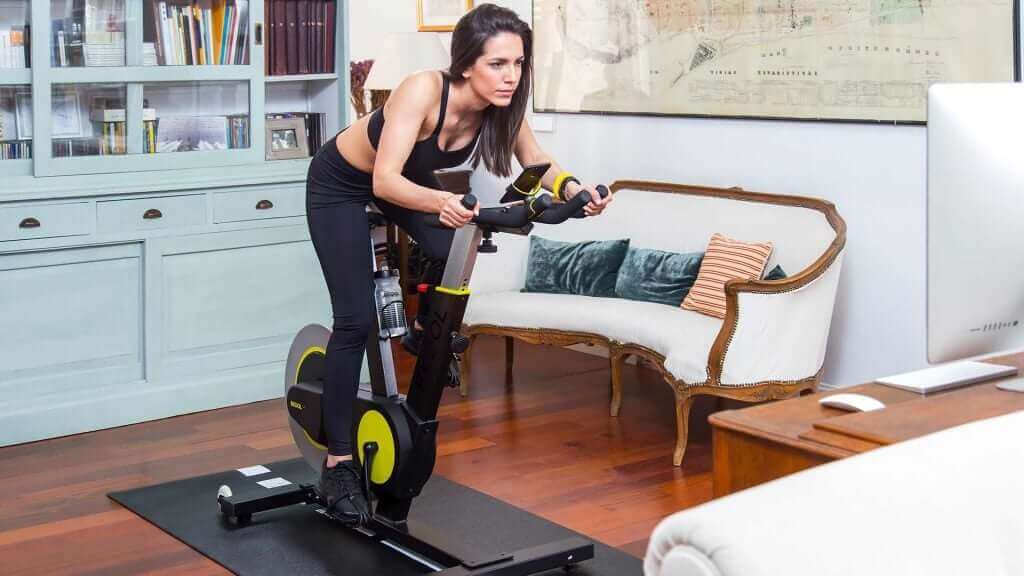 A woman riding a stationary bike.