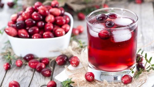 Cranberry juice and cranberries in a bowl.