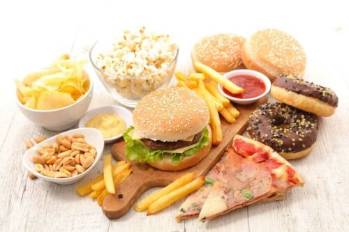 A bunch of junk food on a wooden table.