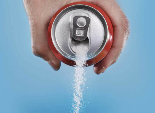 A person holding a can full of sugar.