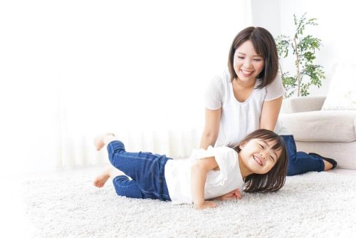 A Japanese child playing with their mother.