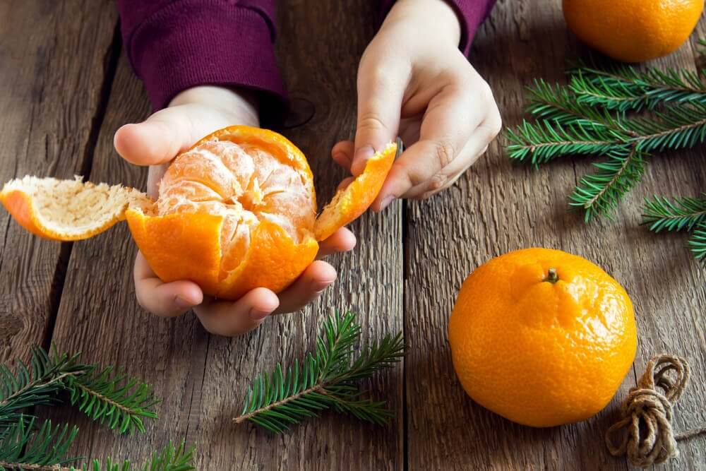 Someone peeling some tangerines