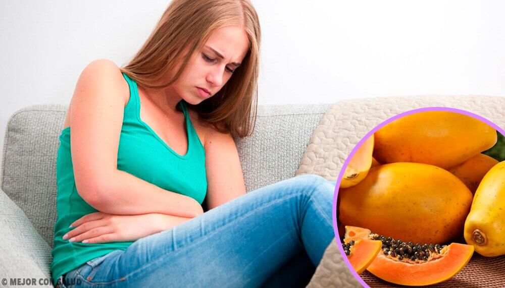 A woman clutching her stomach as she's one of the people with digestive problems.