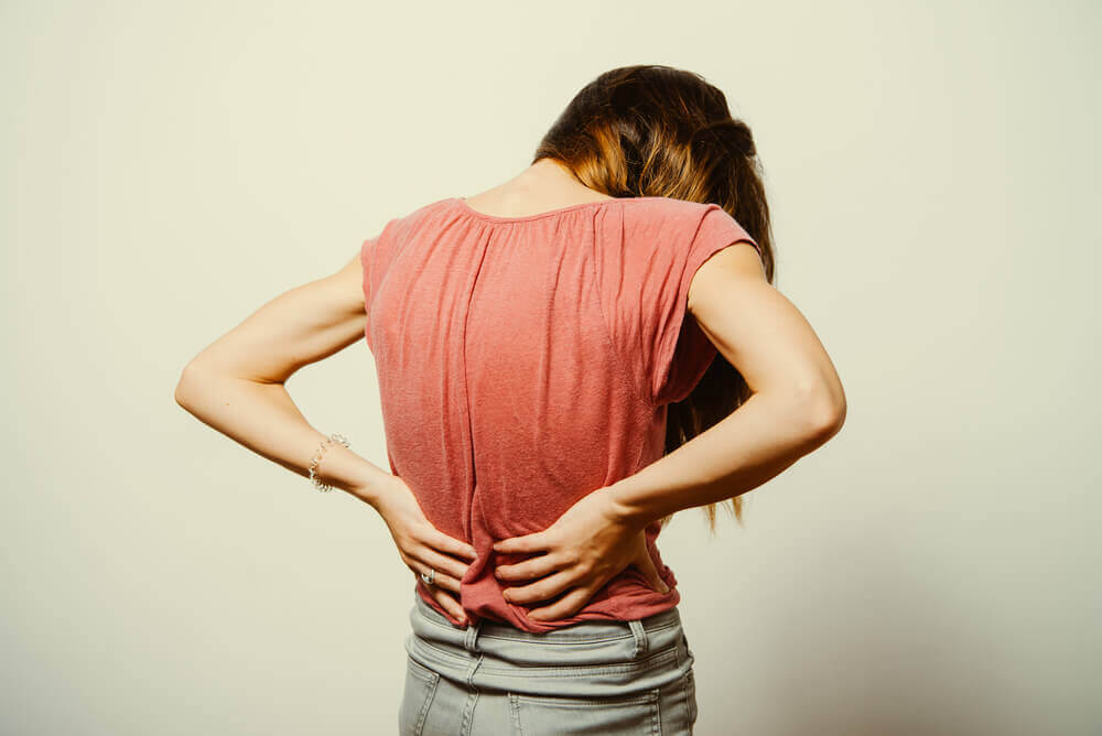 Woman with lower back pain, treat lower back pain