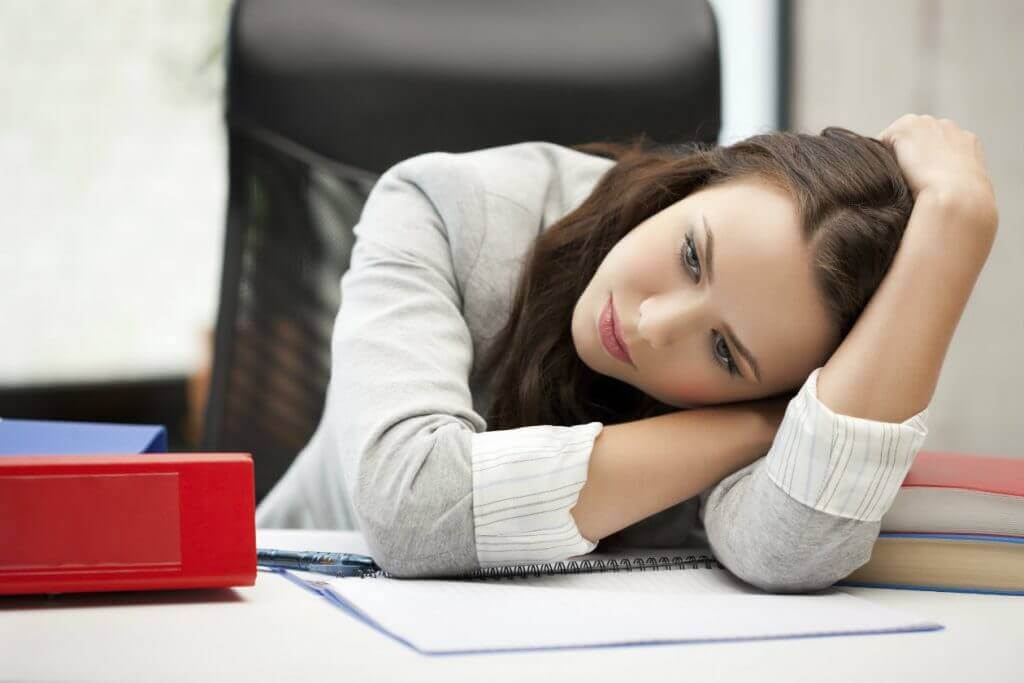 A depressed woman at her desk.