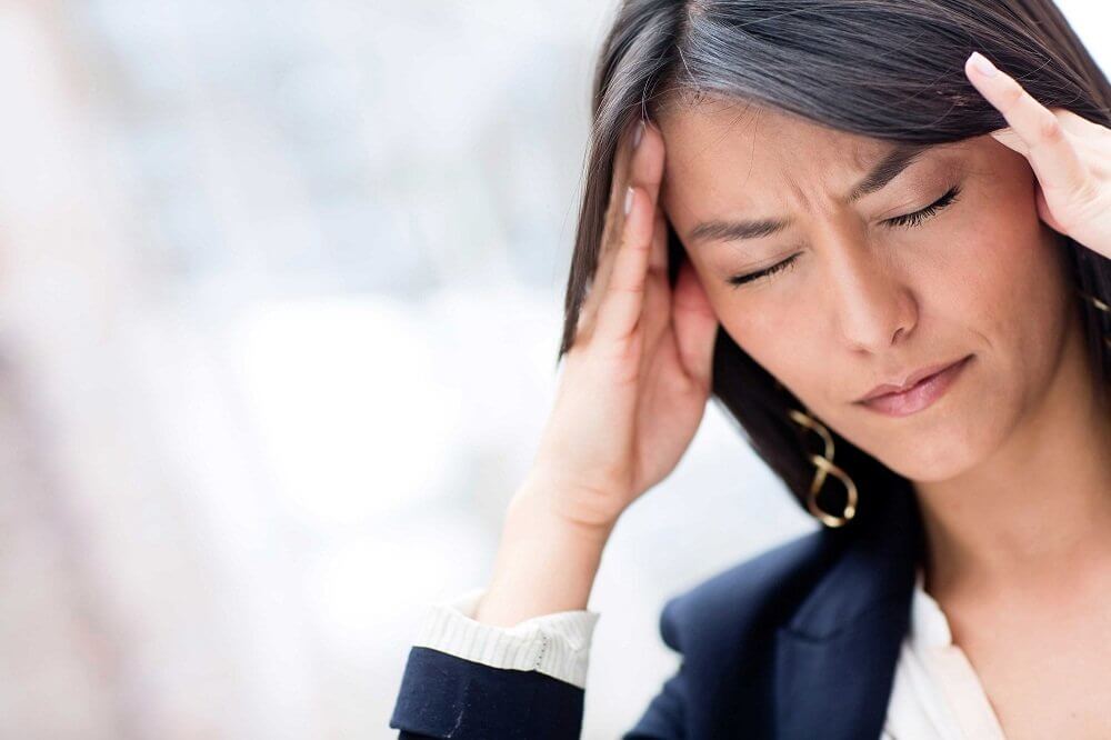 A woman with a migraine.