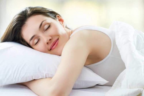 A happy woman sleeping.