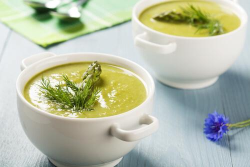 Two bowls of cream of asparagus soup.