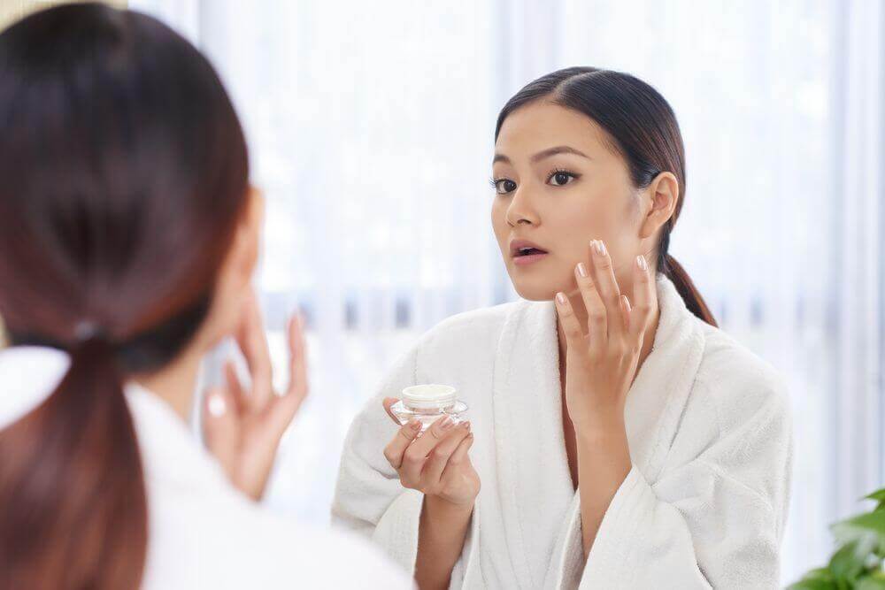 A woman unsure if she should use sunscreen as a moisturizer.