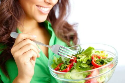 A woman eating a salad.