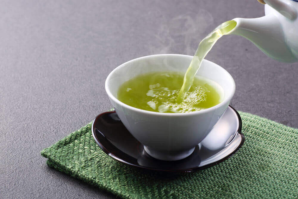Pouring a cup of green tea.