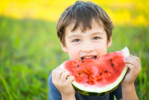 A boy eating a watermelon.
