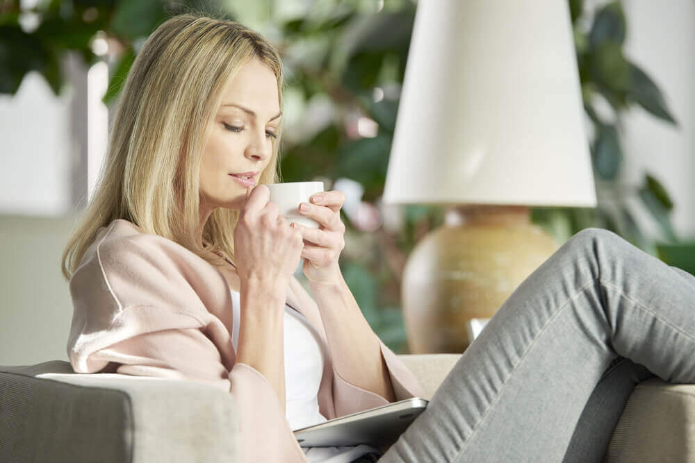 A woman drinking tangerine peel tea.