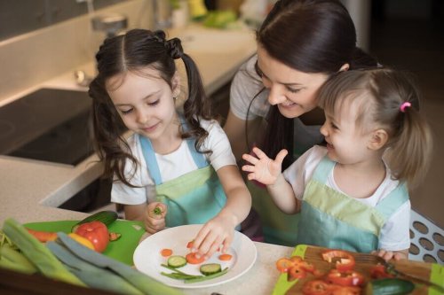 Girls cutting vegetables.